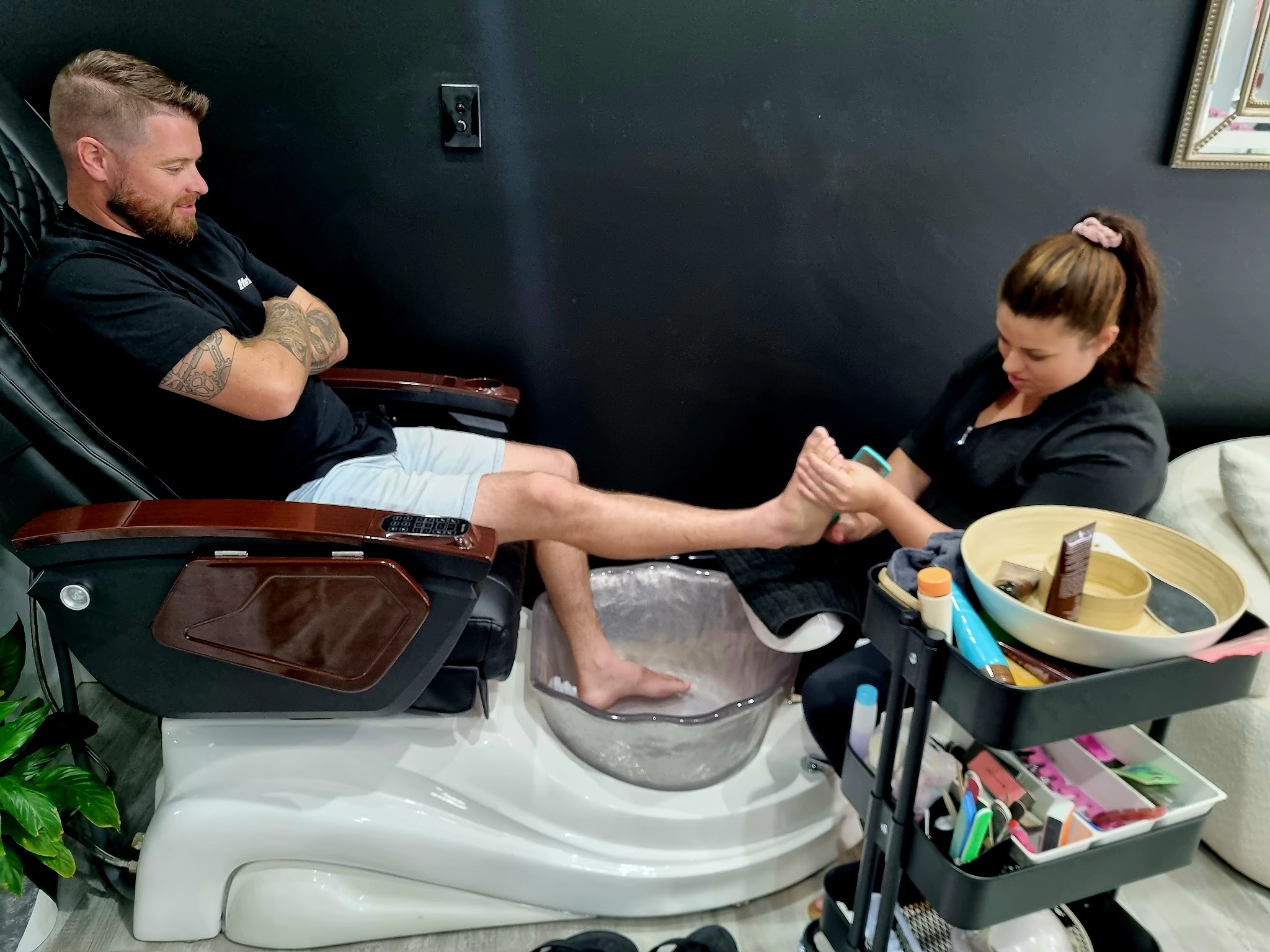 A client relaxing in the pedicure chair while his feet are cared for